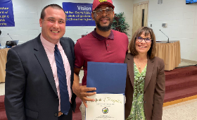 Lead custodian Antone Black Jr., center, receives the Golden Anchor Award at the Kent County Board of Education meeting Wednesday, April 5. Joining him are Kent County Public Schools Supervisor of Human Resources Dan Hushion and Superintendent Dr. Karen C