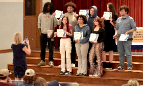 Kent County High School Principal Kris Hemstetter takes a photo of the graduating seniors in the Broadcasting Career and Technical Education pathway during an awards ceremony Tuesday, May 6.