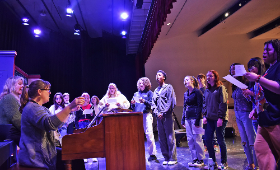 Directors, from left, Lori Armstrong and Jodi Bortz, lead Kent County High School theater students as they rehearse a song from their upcoming production of "Fame." The show will run March 1-3 in the high school's auditorium.