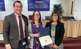 Kent County Middle School English teacher Kaitlyn Wright, center, receives the Golden Anchor Award at a Board of Education meeting Jan. 9. Presenting the award are Kent County Public Schools Supervisor of Human Resources Dan Hushion and Superintendent Dr.