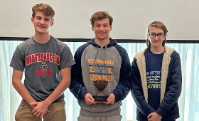 Ben Loller, center, holds the third-place trophy with his Kent County High School teammates Lynden Saunders, left, and Ben Hinton at the Eastern Shore High School Computer Programming Competition.  
