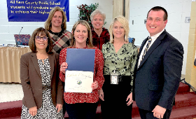Jessica Bennett, school counselor at Kent County High School, receives the Golden Anchor Award Monday, March 13 at a Board of Education meeting. From left are Superintendent Dr. Karen Couch, Supervisor of Student Services and Secondary Education Tracey Wi