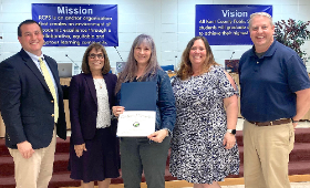 Special education teacher Cheryl Fracassi receives the Golden Anchor Award at a Kent County Board of Education meeting Monday, May 6. From left are Superintendent of Human Resources Dan Hushion, Superintendent Dr. Karen Couch, Fracassi, Supervisor of Spec