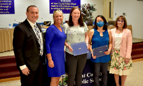 H.H. Garnet Elementary School teachers Christie McElhenny and Laura Morrone receive the Golden Anchor Award at a Kent County Board of Education meeting Monday, May 8. From left are Supervisor of Human Resources Dan Hushion, H.H. Garnet Elementary School P