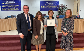 Galena Elementary School custodian Michelle Crouch receives the Golden Anchor Award Monday, Oct. 9 for her hard work. From left are Kent County Public Schools Supervisor of Human Resources Dan Hushion, Superintendent Dr. Karen Couch, Crouch and Galena Ele