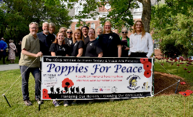 Kent County High School students pose for a photo with local artists and representatives from community organizations who helped bring the Poppies for Peace project to fruition.