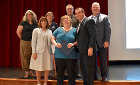 Ginnie Walls, center, is honored for her 50-year career with Kent County Public Schools by the Board of Education, Superintendent Dr. Karen Couch and Supervisor of Human Resources Dan Hushion.