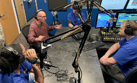 Bruce Warren, second from left, of WXPN in Philadelphia talks with WKHS student DJs, from left, Olivia Johnson, Jonah Elburn and John Singleton on air Thursday, Feb. 9 in the Kent County High School studio.
